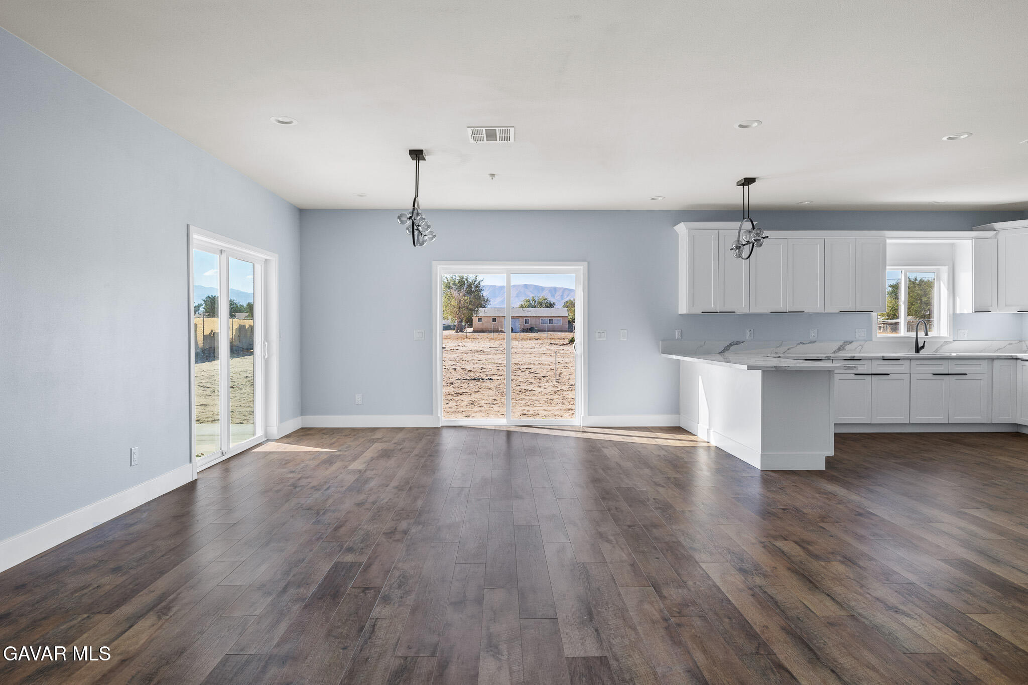 10708 East Ave R 14 Littlerock, CA 93543 - Photo 6 of 38 a large kitchen with hard wood floors and stainless steel appliances