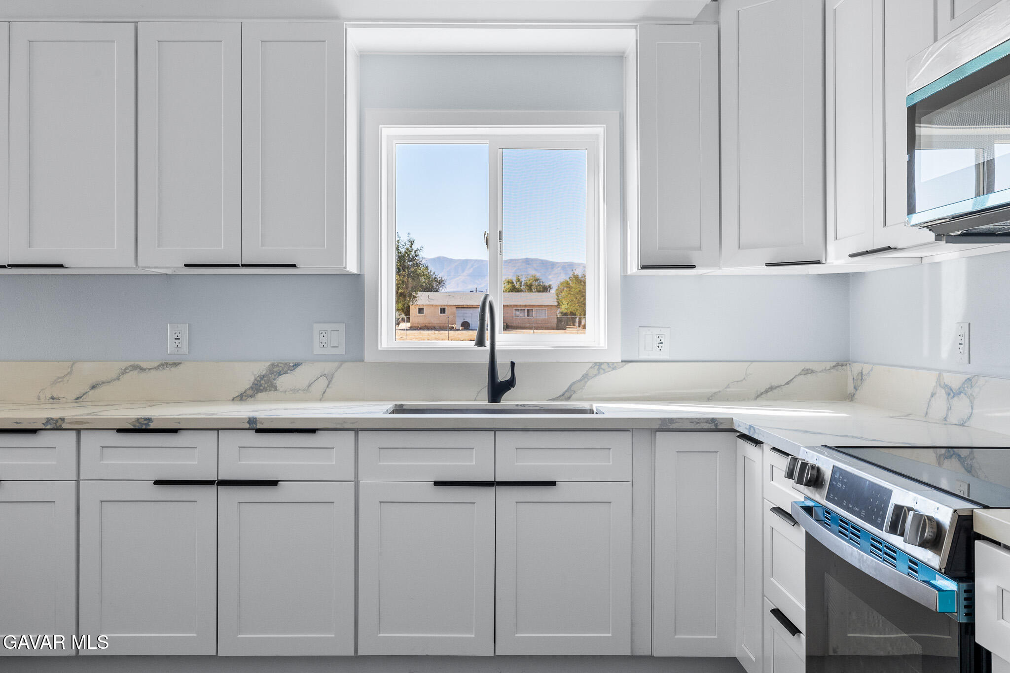 10708 East Ave R 14 Littlerock, CA 93543 - Photo 10 of 38 a kitchen with stainless steel appliances granite countertop a sink and cabinets