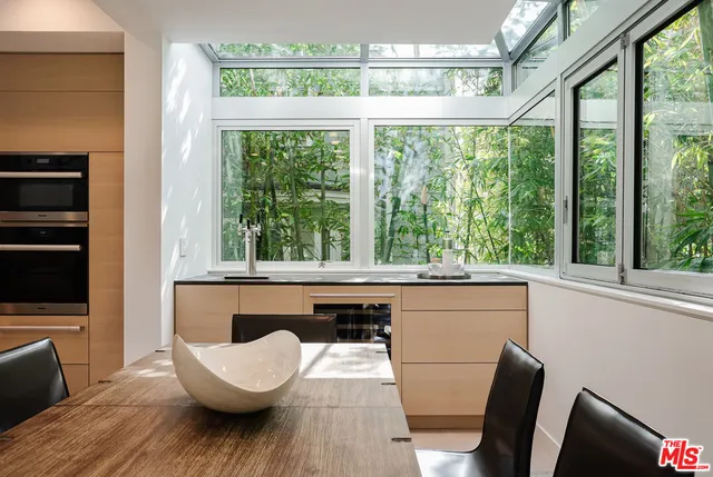 a kitchen with a sink and a large window