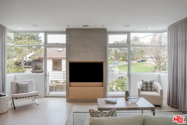 a bedroom with a bed and large window