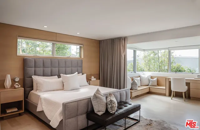 a living room with a large window and a table