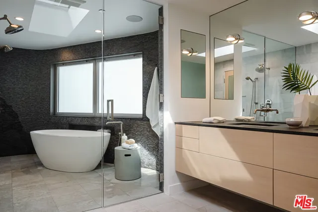 a spacious bathroom with a double vanity sink a mirror and a bathtub
