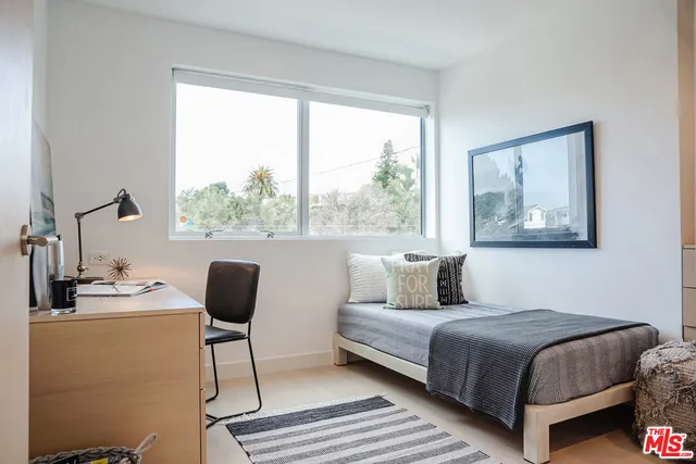 a view of a patio with couches table and chairs and potted plants
