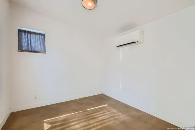 a view of a livingroom with a fireplace and wooden floor