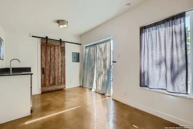 a view of a kitchen with refrigerator and stove