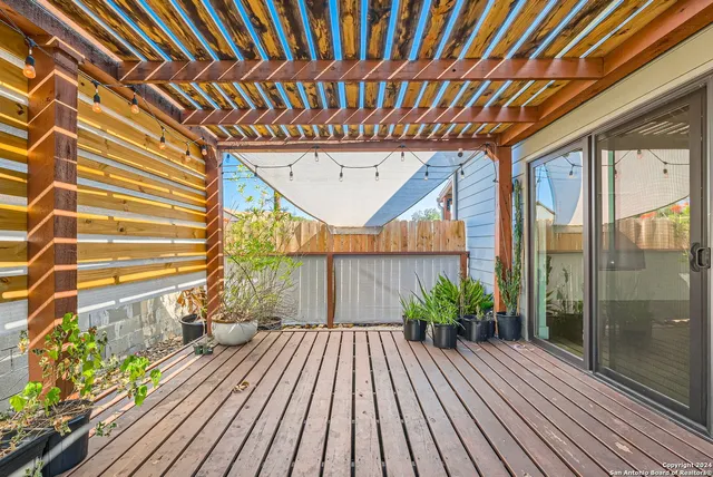 a backyard of a house with table and chairs