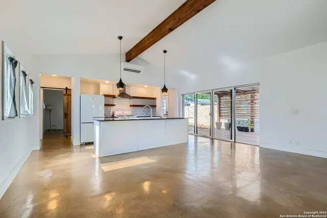 a view of a kitchen with a stove top oven