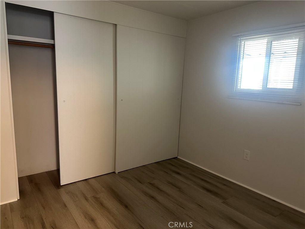 3210-23 Santa Maria Santa Maria, CA 93455 - Photo 14 of 17 a view of an empty room with wooden floor and a window