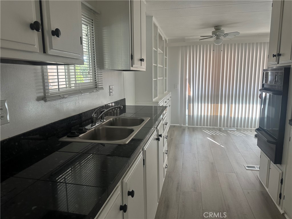 3210-23 Santa Maria Santa Maria, CA 93455 - Photo 5 of 17 a kitchen that has a sink and a stove