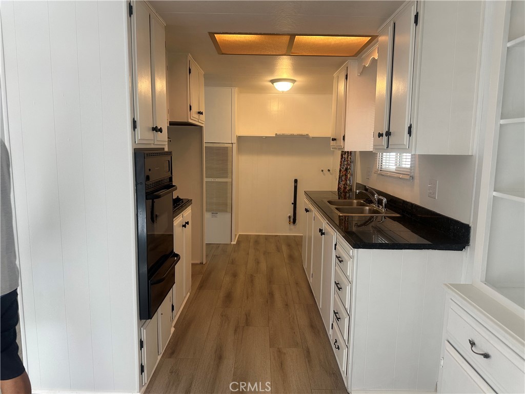 3210-23 Santa Maria Santa Maria, CA 93455 - Photo 8 of 17 a kitchen with a sink and wooden floor