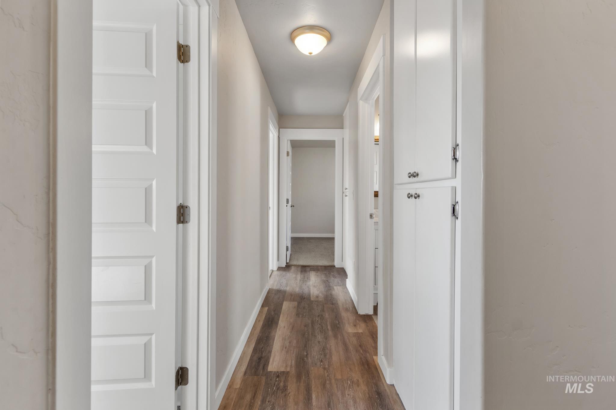 4822 Charme Street Caldwell, ID 83607 - Photo 11 of 22 Corridor with baseboards and dark wood finished floors