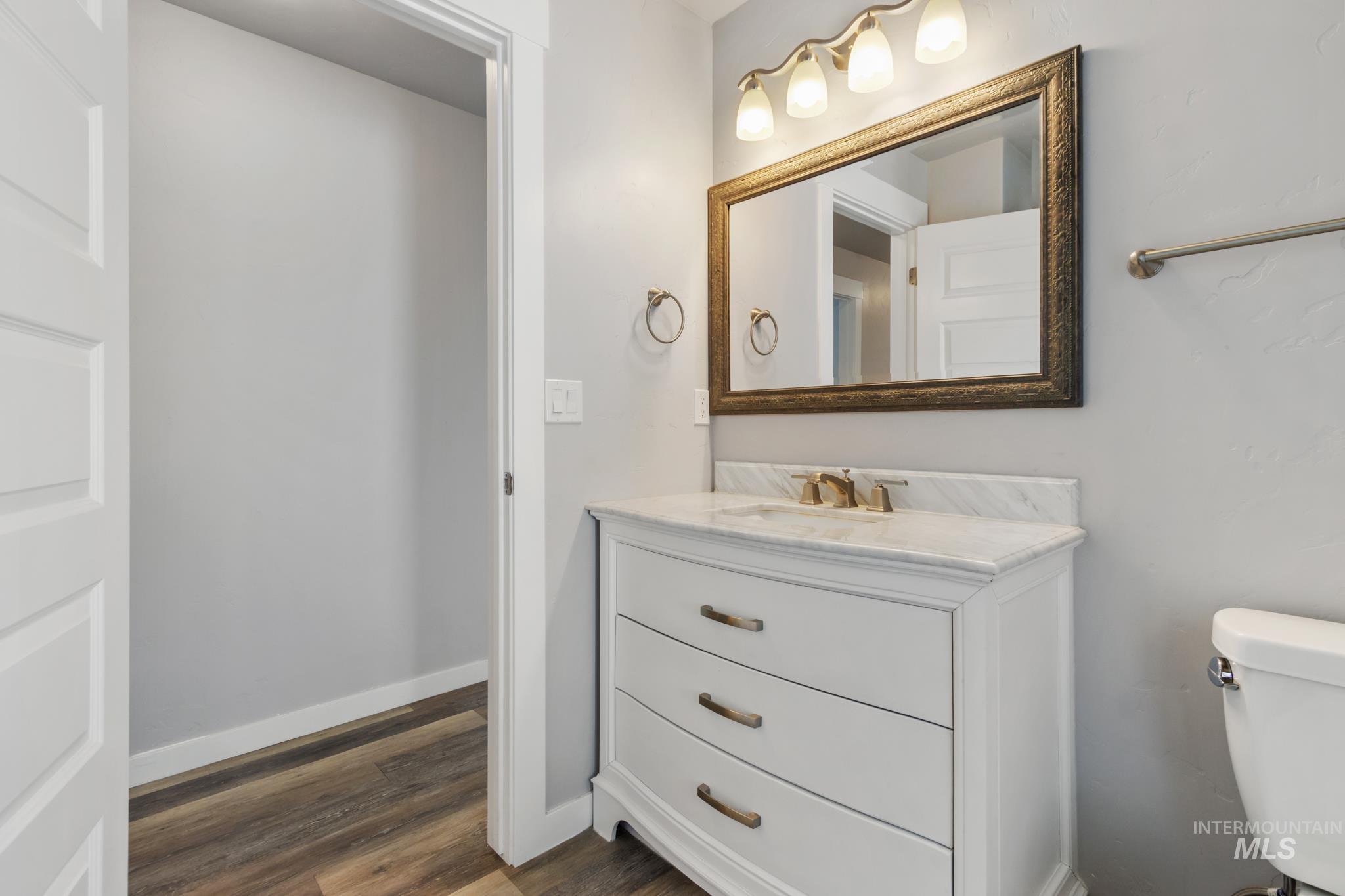 4822 Charme Street Caldwell, ID 83607 - Photo 14 of 22 Half bath with vanity and dark wood-type flooring