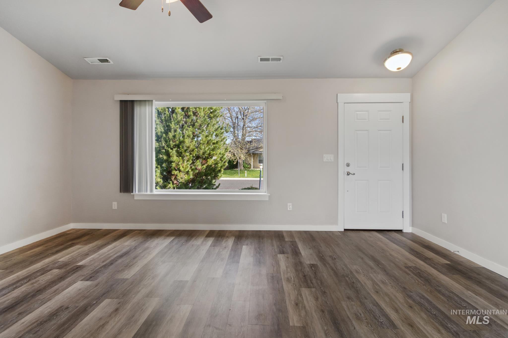 4822 Charme Street Caldwell, ID 83607 - Photo 3 of 22 Foyer with a ceiling fan and dark wood-style floors