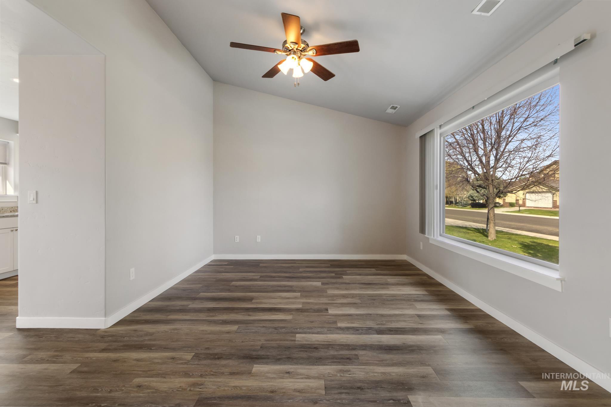 4822 Charme Street Caldwell, ID 83607 - Photo 5 of 22 Spare room featuring a ceiling fan and dark wood-type flooring