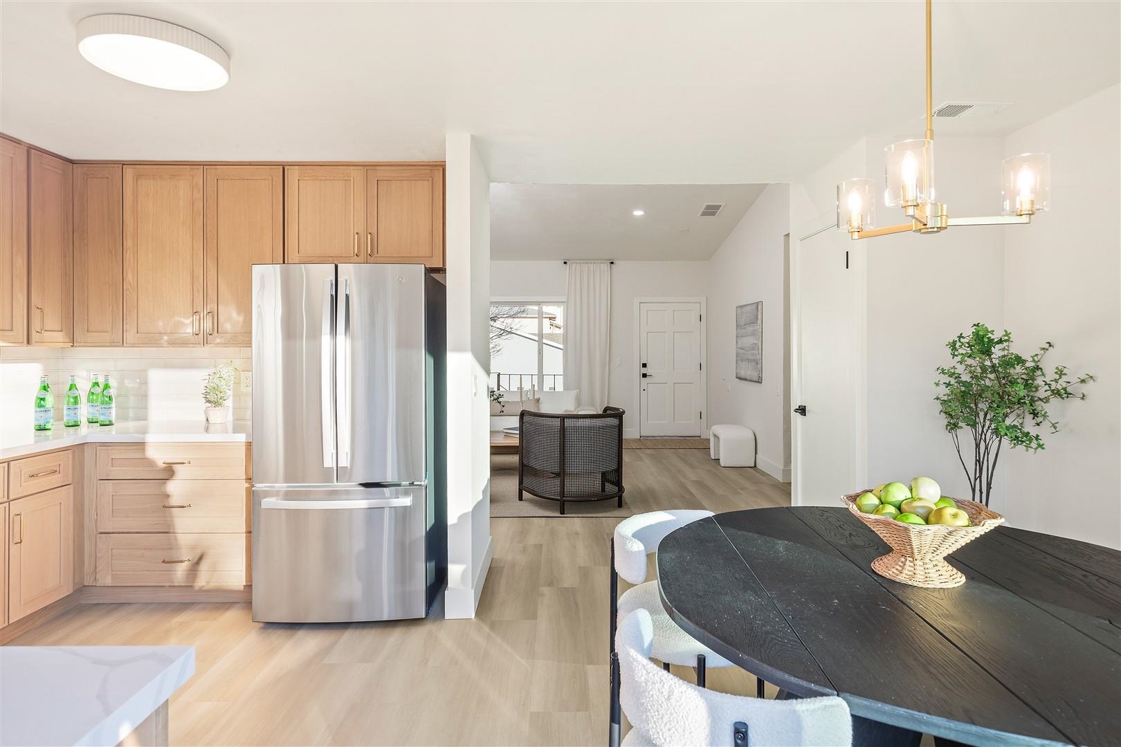 2973 Ralston Way Hayward, CA 94541 - Photo 11 of 55 Kitchen featuring freestanding refrigerator, pendant lighting, light wood-style floors, light brown cabinets, and backsplash