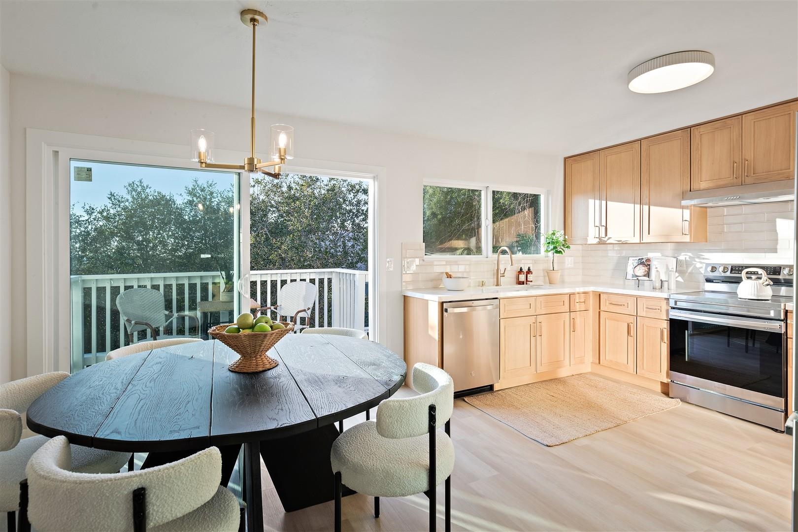 2973 Ralston Way Hayward, CA 94541 - Photo 13 of 55 Kitchen with stainless steel appliances, decorative light fixtures, under cabinet range hood, a chandelier, and backsplash