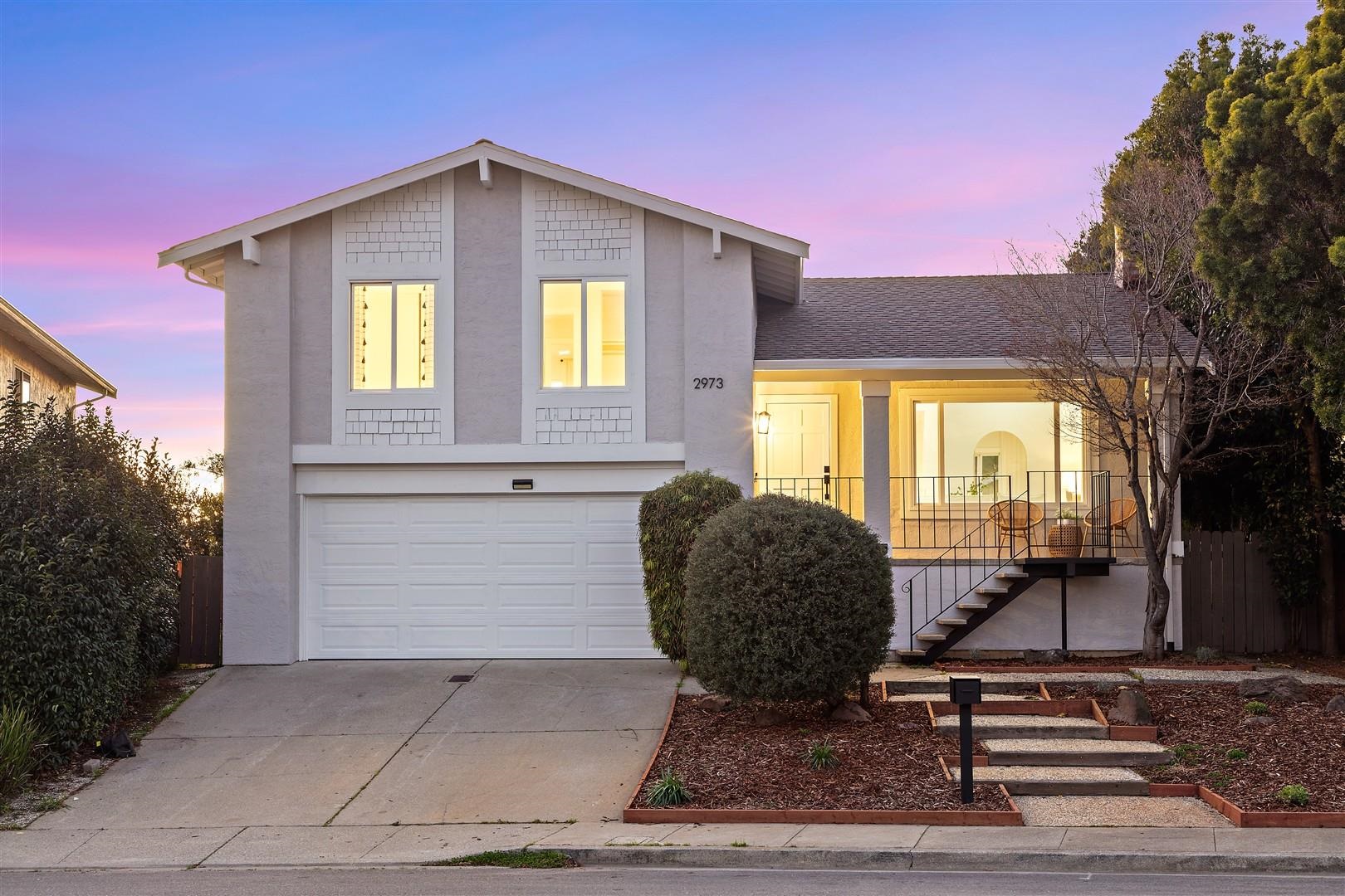 2973 Ralston Way Hayward, CA 94541 - Photo 2 of 55 View of front facade with stairway, a porch, driveway, a shingled roof, and stucco siding