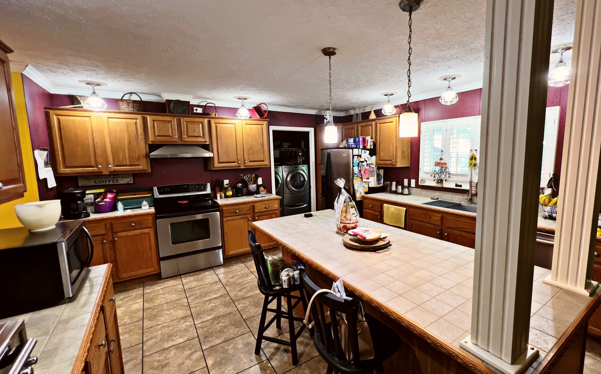 4027 Forrest Hill Road Bolivar, TN 38008 - Photo 11 of 32 a kitchen with stainless steel appliances kitchen island granite countertop a table chairs and a refrigerator