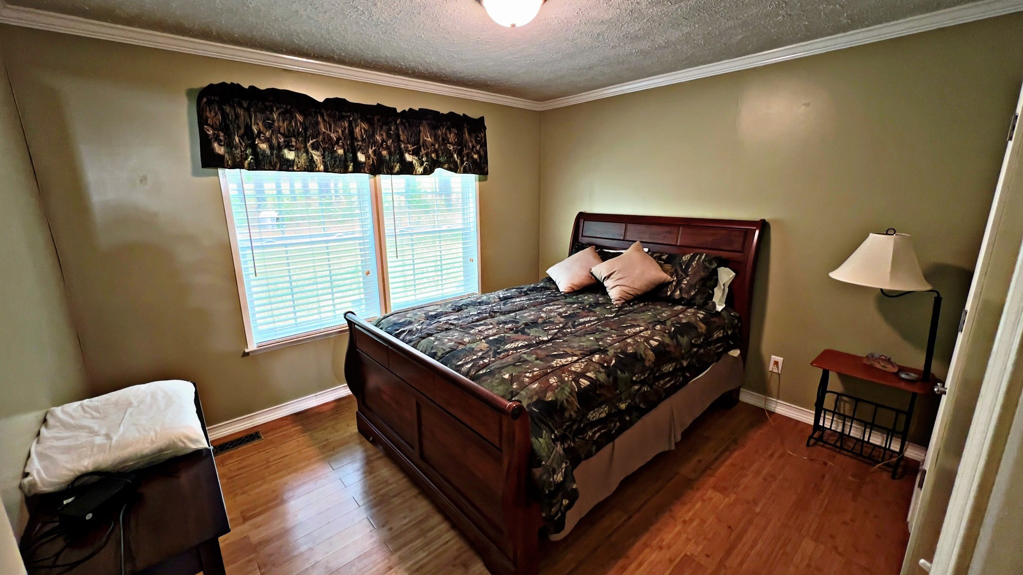 4027 Forrest Hill Road Bolivar, TN 38008 - Photo 18 of 32 a bed sitting in a bedroom next to a window