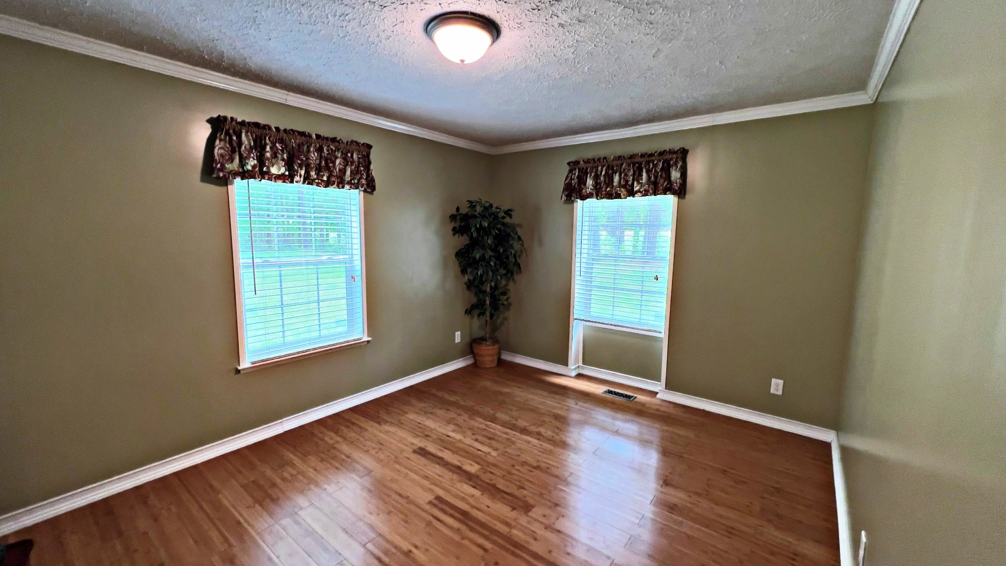 4027 Forrest Hill Road Bolivar, TN 38008 - Photo 19 of 32 an empty room with wooden floor and windows