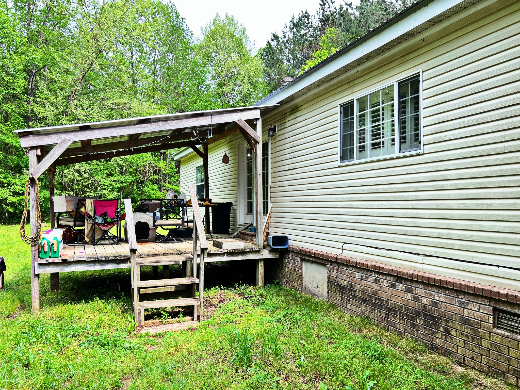 4027 Forrest Hill Road Bolivar, TN 38008 - Photo 27 of 32 a backyard of a house with wooden floor and outdoor seating