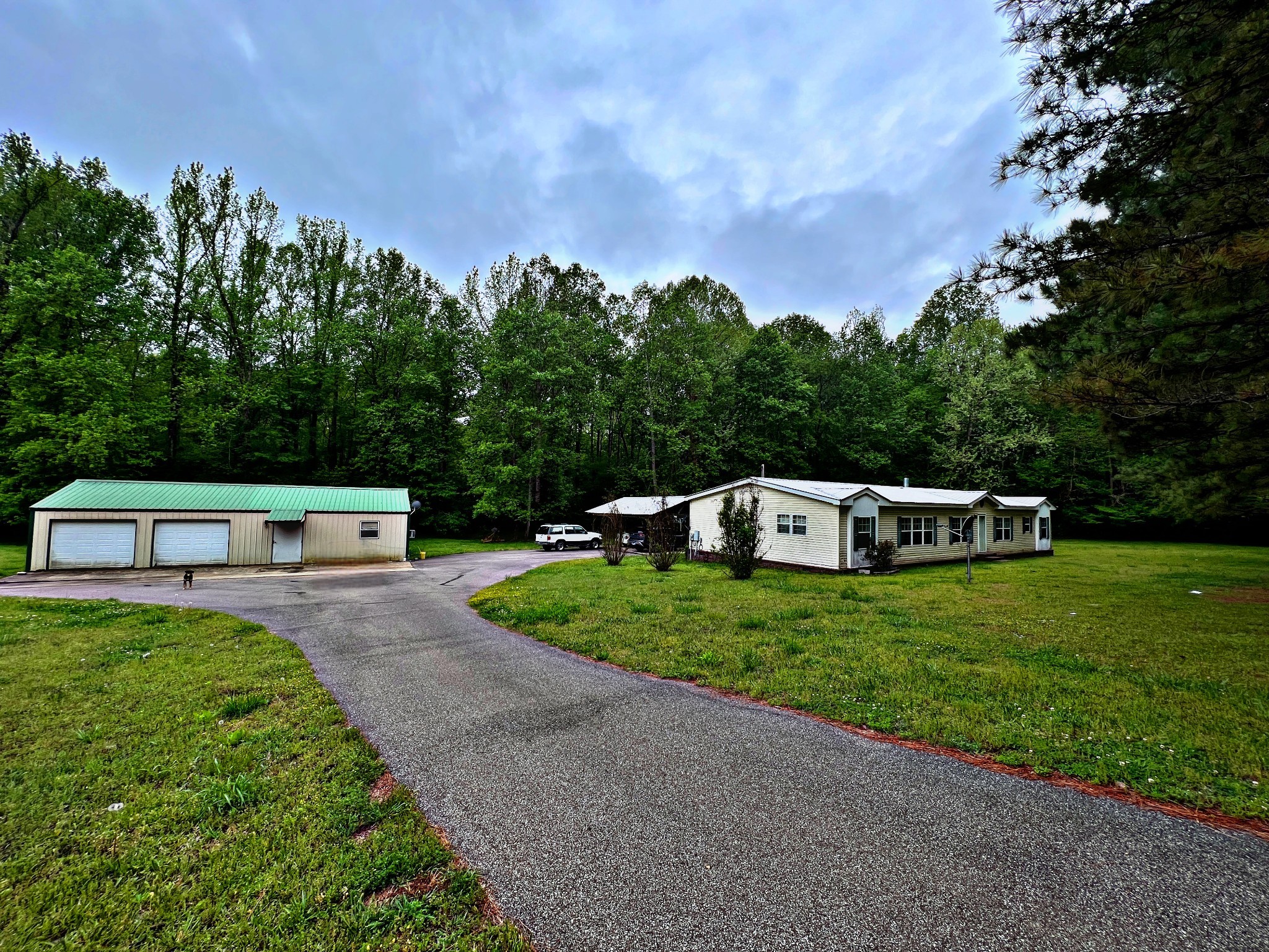 4027 Forrest Hill Road Bolivar, TN 38008 - Photo 4 of 32 a front view of a house with a garden