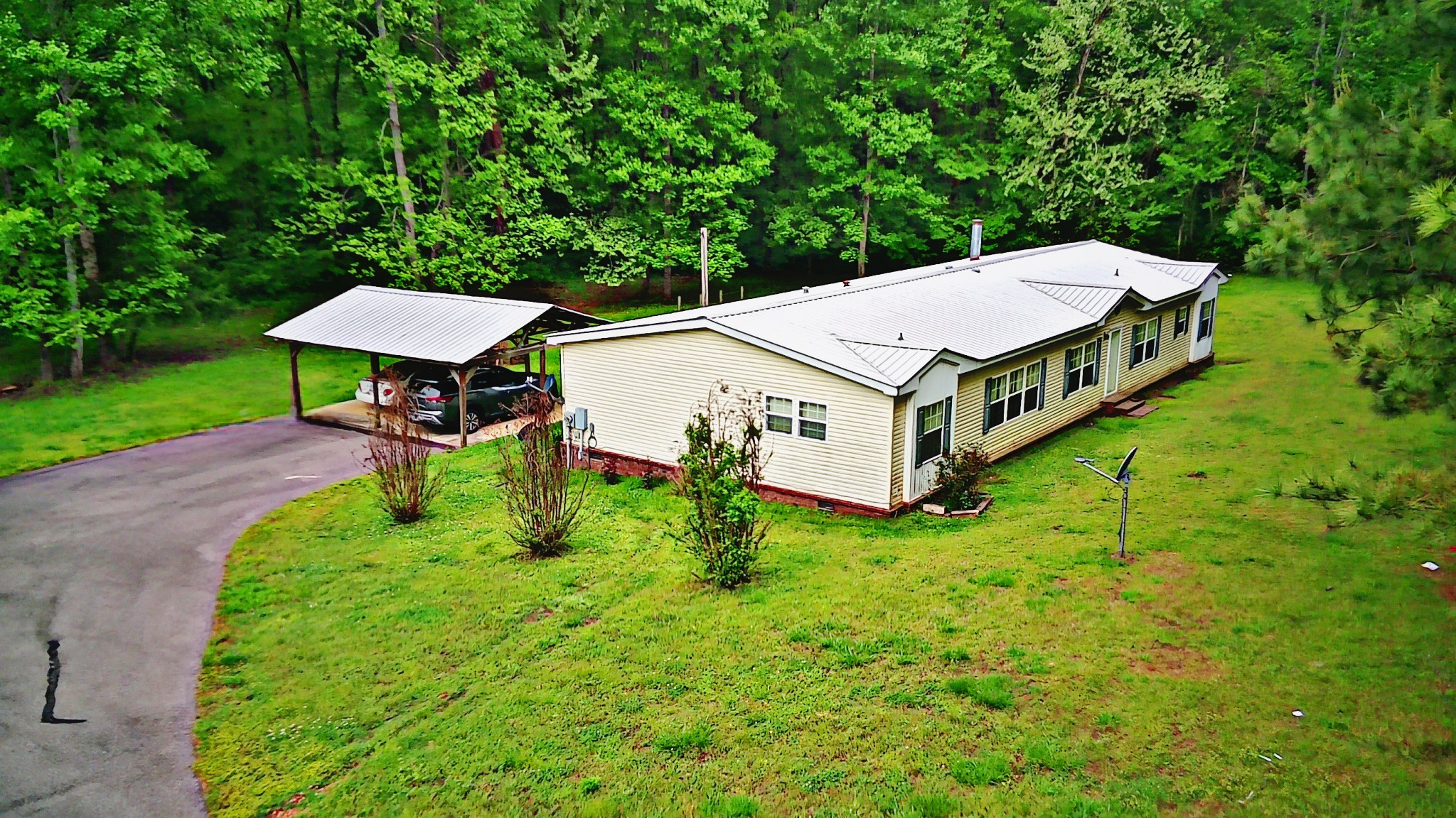 4027 Forrest Hill Road Bolivar, TN 38008 - Photo 5 of 32 an aerial view of a house with porch and a yard
