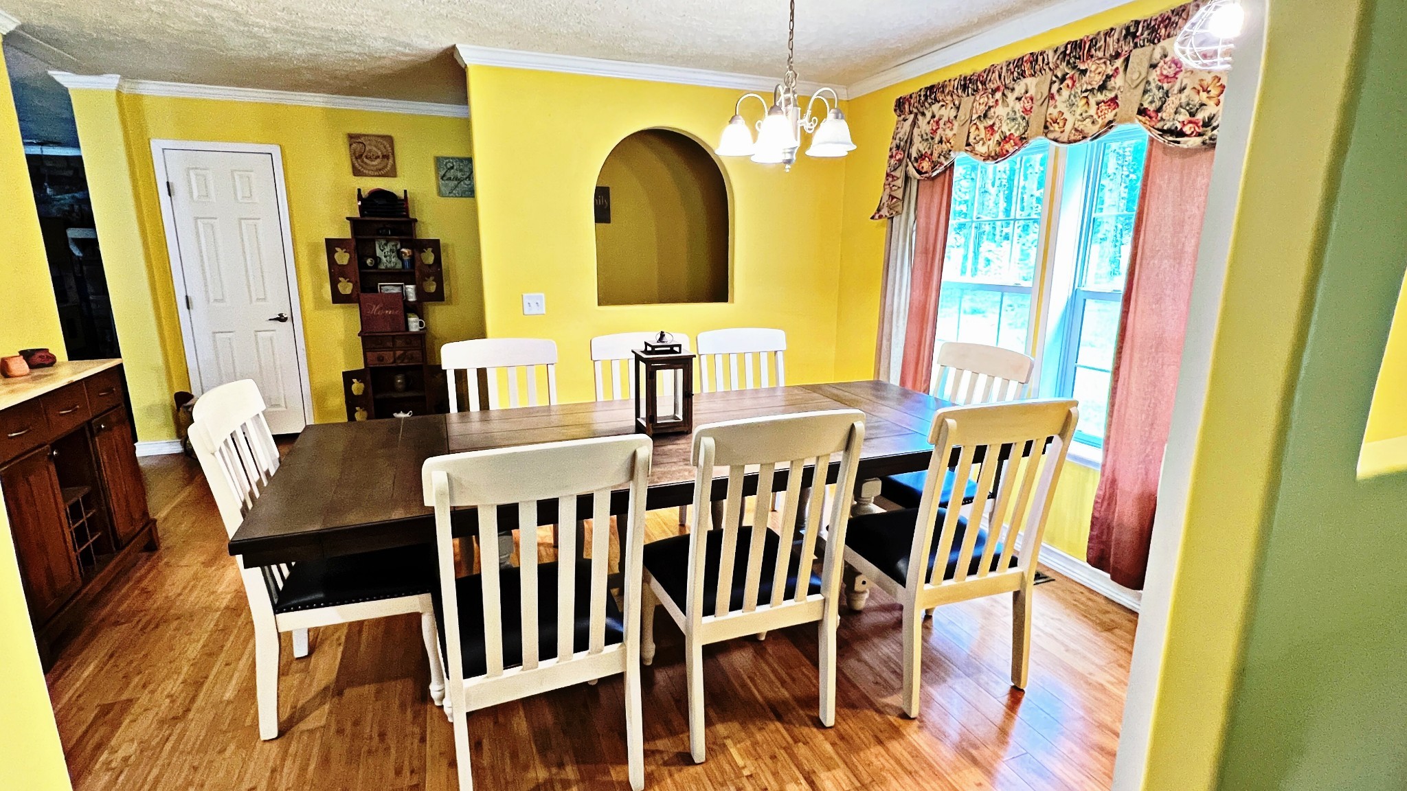 4027 Forrest Hill Road Bolivar, TN 38008 - Photo 8 of 32 a view of a dining room with furniture and chandelier