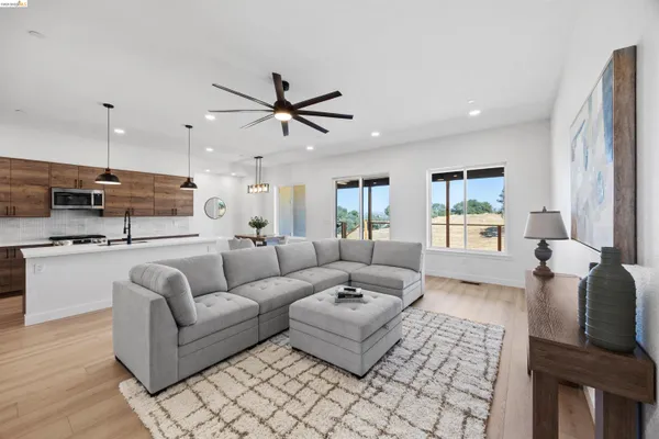 a living room with furniture and kitchen view