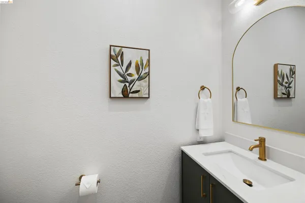 a bathroom with a sink a toilet and mirror