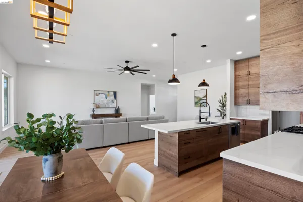 a kitchen with kitchen island stainless steel appliances a stove a sink a center island a window and a kitchen view