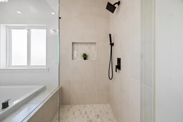 a bathroom with a bathtub and a shower