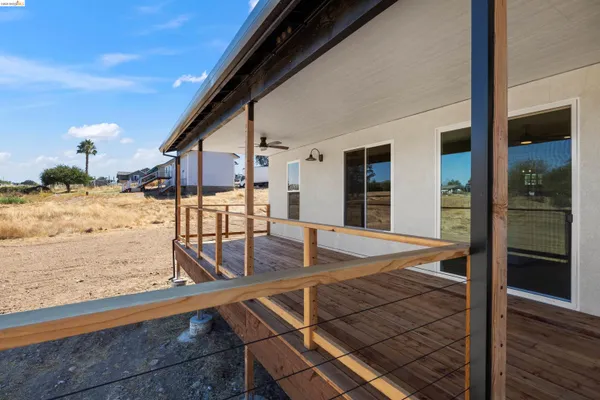 a view of a balcony with furniture and wooden floor