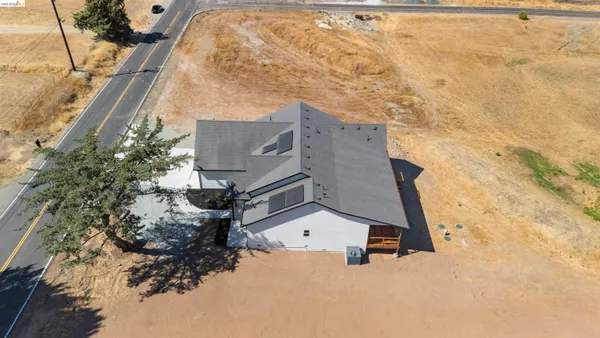 a wooden house with a large tree in front of it