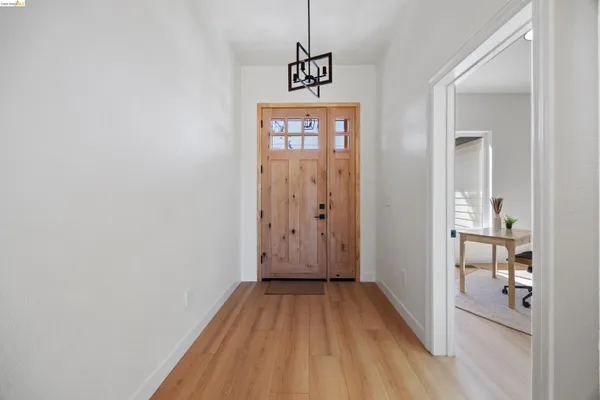 a view of hallway with wooden floor
