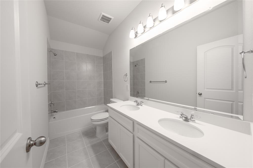 2613 Spade Street Anna, TX 75409 - Photo 23 of 38 a bathroom with a sink a toilet and shower
