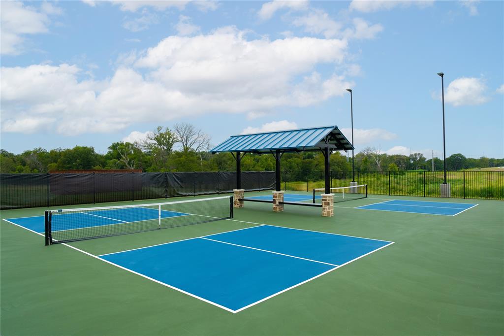 2613 Spade Street Anna, TX 75409 - Photo 34 of 38 a view of a tennis court with a flat screen tv