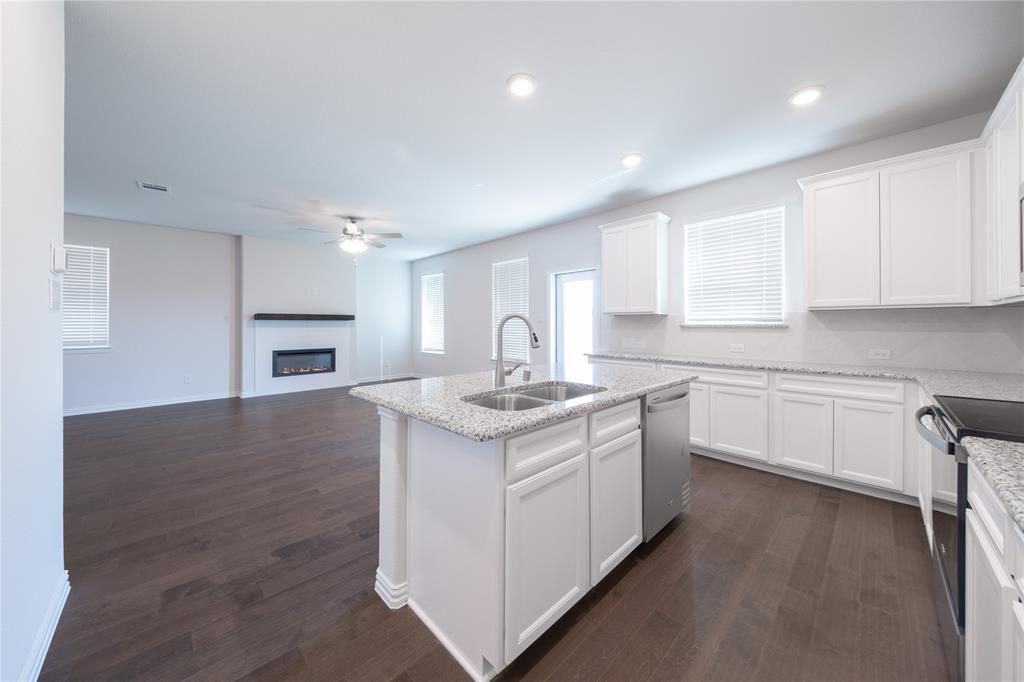 2613 Spade Street Anna, TX 75409 - Photo 5 of 38 a kitchen with a sink stove and cabinets