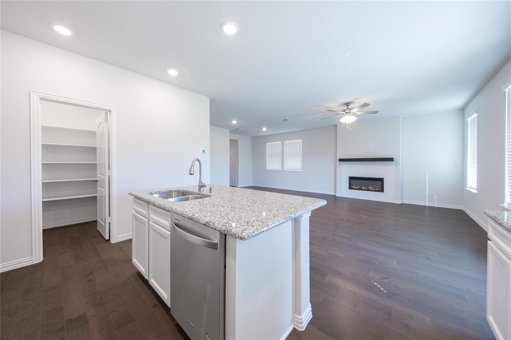 2613 Spade Street Anna, TX 75409 - Photo 6 of 38 a kitchen with a stove and a wooden floors