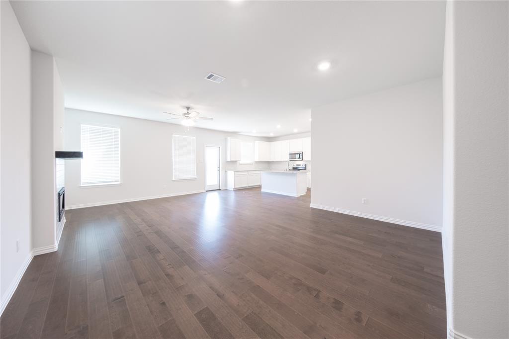 2613 Spade Street Anna, TX 75409 - Photo 7 of 38 a view of empty room with wooden floor and windows