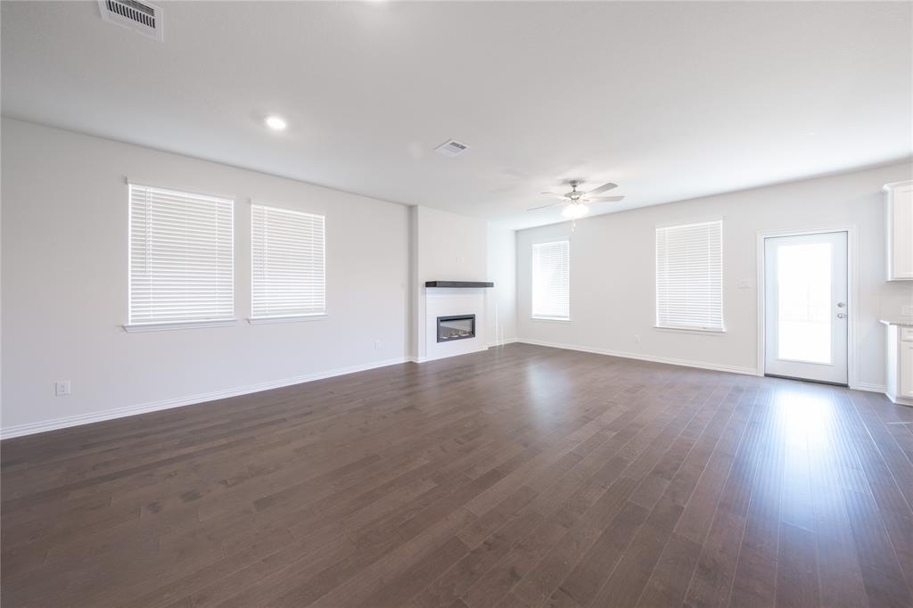 2613 Spade Street Anna, TX 75409 - Photo 8 of 38 a view of a livingroom with wooden floor and a window