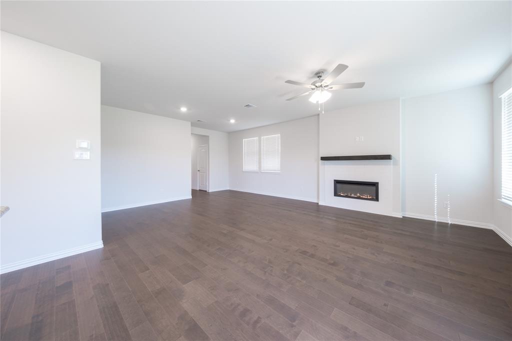 2613 Spade Street Anna, TX 75409 - Photo 9 of 38 a view of empty room with wooden floor and fan