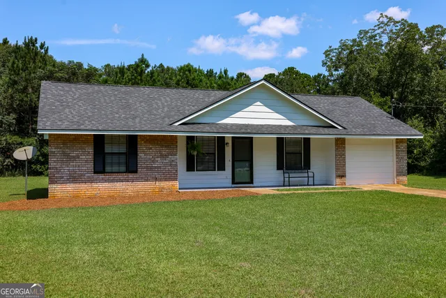 a front view of a house with a garden and porch