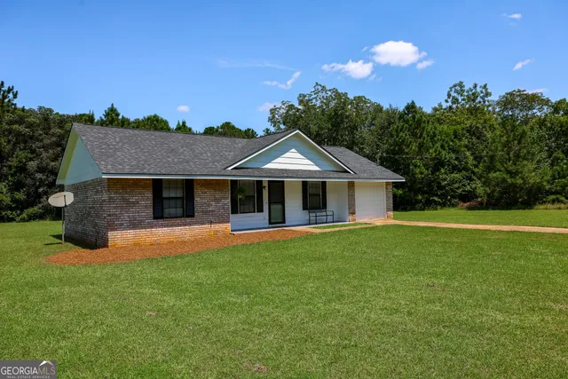 a front view of house with yard and green space