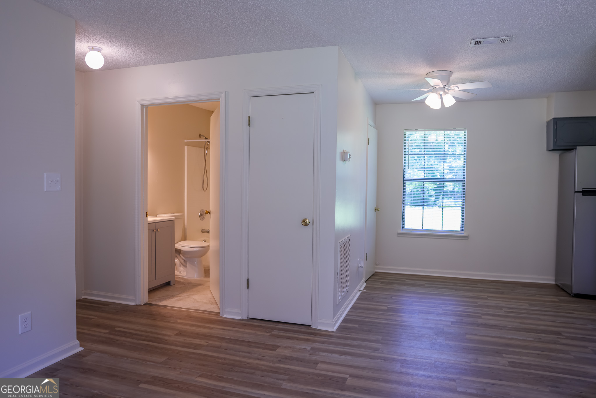540 Veneys Mill Pond Road Parrott, GA 39877 - Photo 5 of 21 a view of an empty room with wooden floor and a window