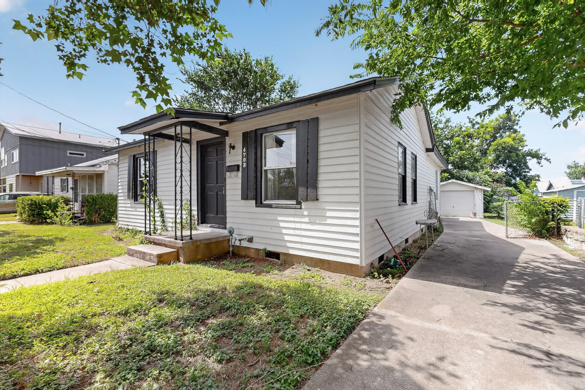 4703 Leslie Avenue Austin, TX 78721 - Photo 2 of 34 A classic facade with a covered entry welcomes you home, alongside a lengthy driveway leading to a detached garage.