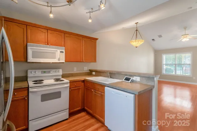 a kitchen with a stove a sink and a microwave