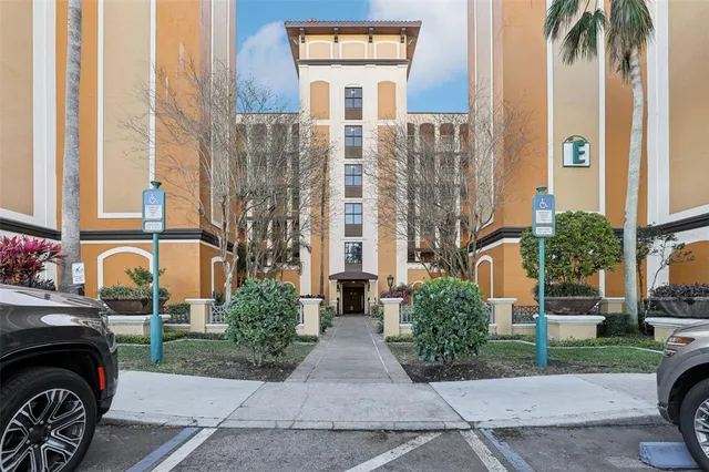a front view of a residential apartment building with a yard