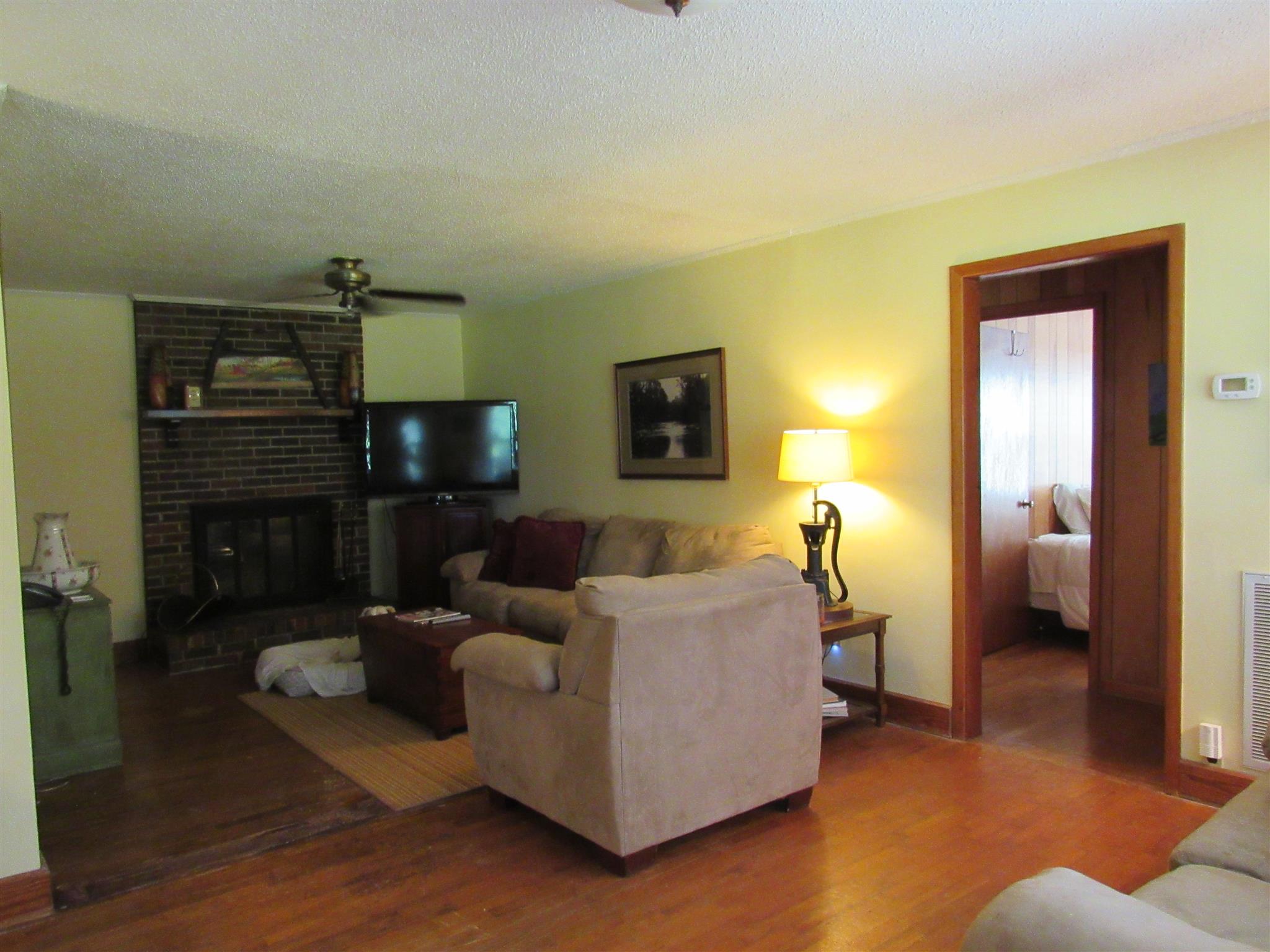 4580 Shannon Creek Road Goodspring, TN 38460 - Photo 23 of 25 a living room with furniture and a fireplace