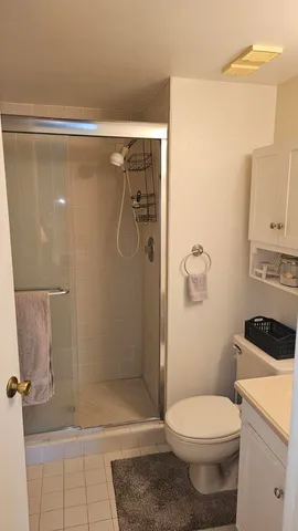 a view of a cabinet and an empty room with windows